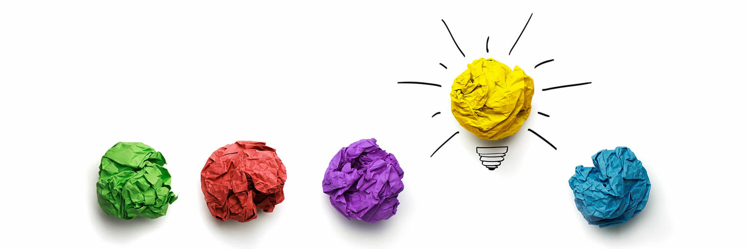 challenge your decision making -  illustration (paper wads, light bulb)