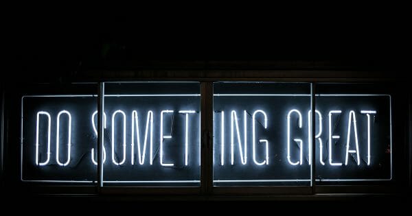 How to have a great sales conference - Do something great neon sign - Photo by Clark Tibbs on Unsplash