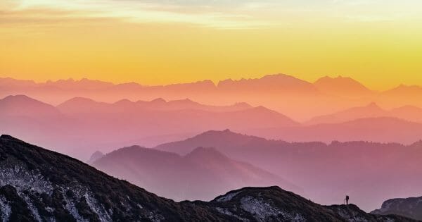 Contributing as a Multiplier - hiker on mountaintop - Photo by Simon Matzinger on Unsplash