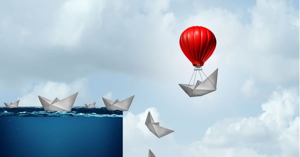 Leading in a Crisis (art of paper ships falling off a cliff except one is saved by a hot air balloon)