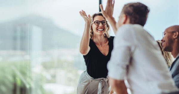 New 'ecosystem' for manager development goes beyond traditional training (managers giving a high five)