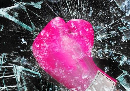Breaking Bias - imnage of pink boxer's glove smashing glass