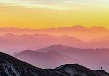 Contributing as a Multiplier - hiker on mountaintop - Photo by Simon Matzinger on Unsplash